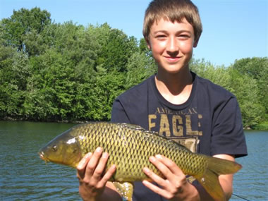 Austin Appleby with the smallest catch of the day, a 5 lb, 6 oz common that won him a prize when no one else landed a carp during that hour