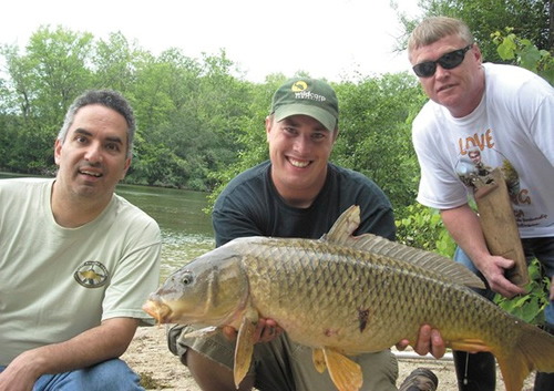 James Daher, from Mickey’s Bait & Tackle, Jason Bernhardt, Wild Carp Co. and weigh marshal, David France, show off a catch at one of the tournament pegs at the carp tournament hosted Saturday during the Free Fishing Weekend on Onondaga Lake.