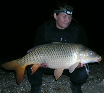 Wild Carp Club of Indiana Director Christine Stout  with a 26.8 lb mirror carp caught at Dale Hollow Lake in TN