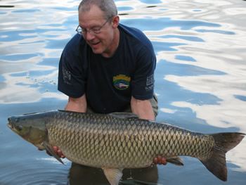 Wild Carp Club of Austin Director Keith Thompson with a large grass carp.